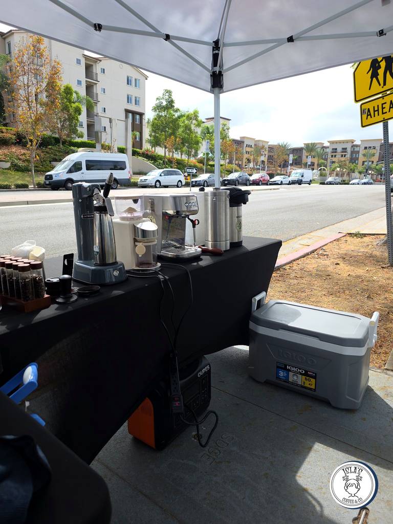 Isla's Coffee espresso setup under canopy at the pop-up